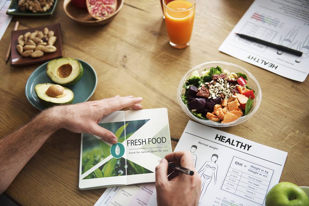 a table of a dietitian and she is working on a instruction sheet