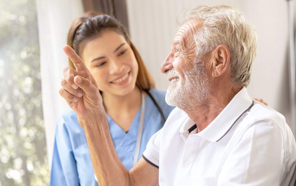 a nurse is communicating with an elderly mental health patient