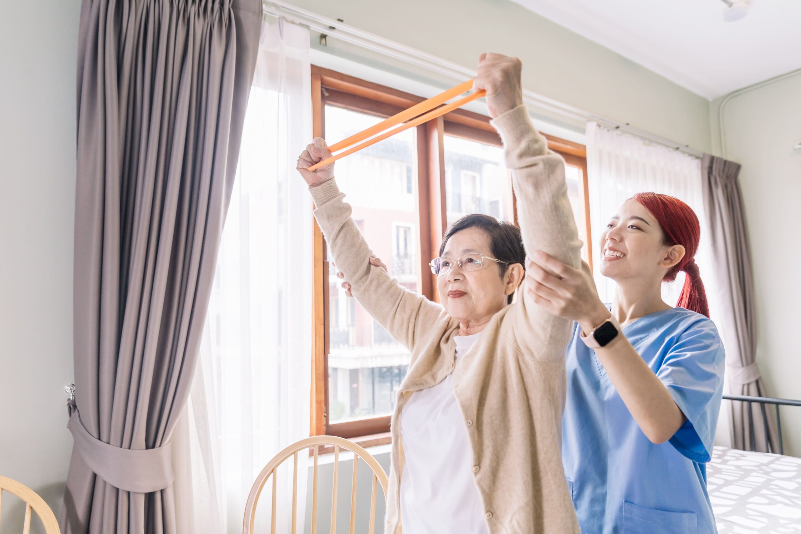 a physiotherapist is helping a woman doing exercise