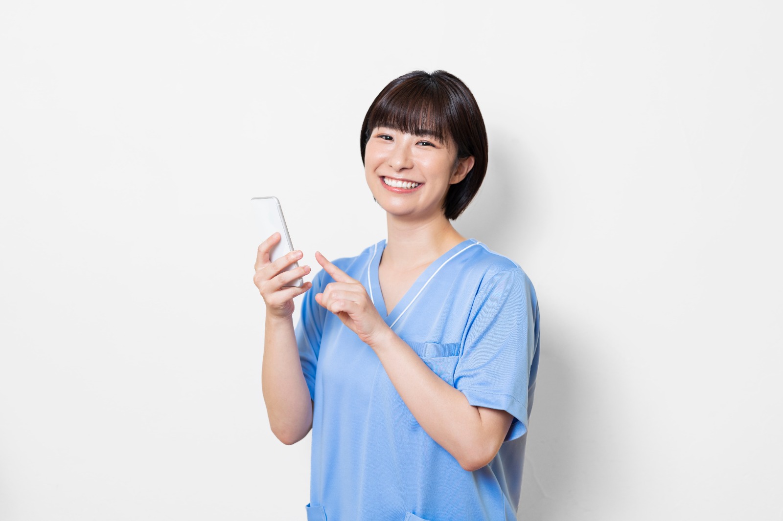 a nurse holding a mobile phone with a big smile