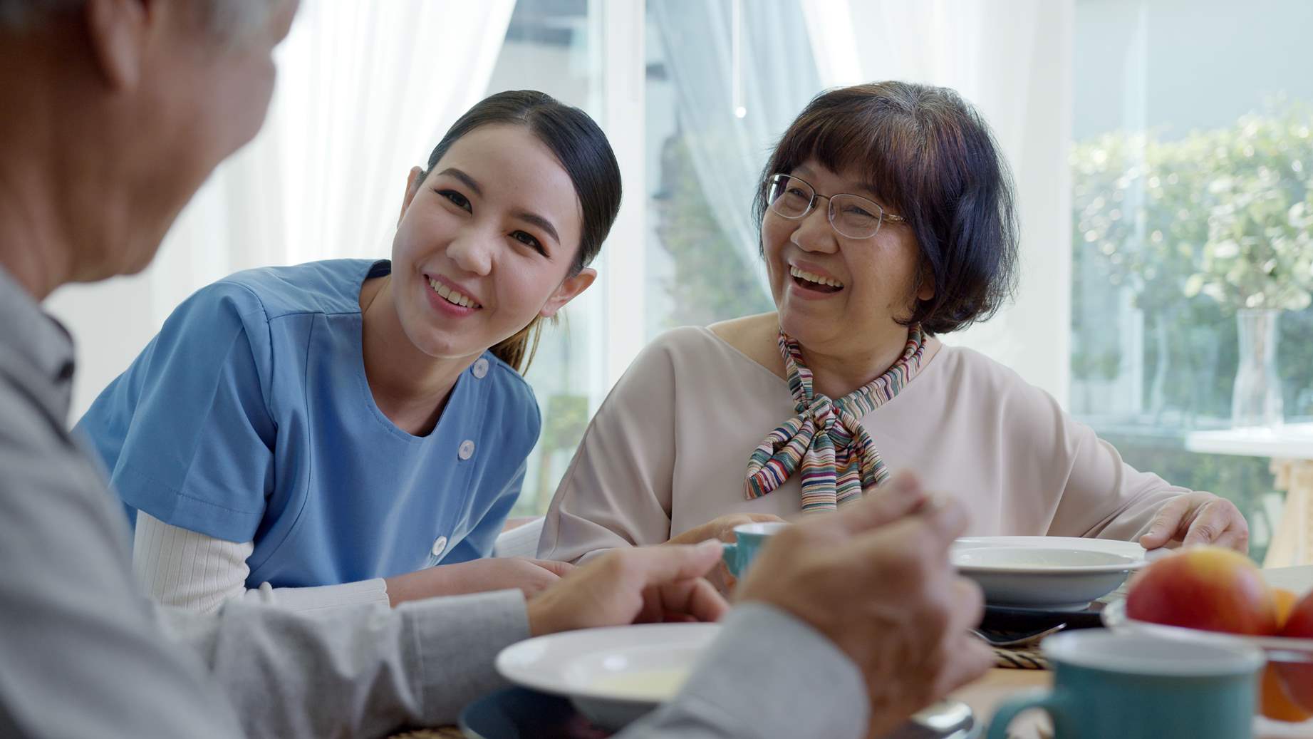 nurse serving a meal to client